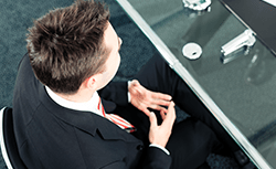 person in suit at desk