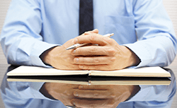 person with pen and notebook